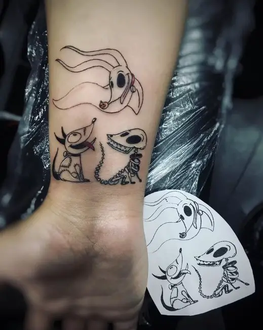 Dog sleeve tattoo of Tim Burton's characters.